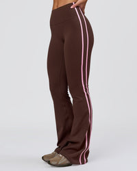 Woman wearing Fusion V-Contour Bind High-Rise Flared Legging - Hot Chocolate-Pink Rose | Model:Issy | Size:XS | Thumbnail Index: 0
