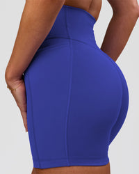 Woman wearing Fusion V-Contour Ultra High-Rise 4" Short Pockets - Power Cobalt | Model:Issy | Size:XS | Thumbnail Index: 2