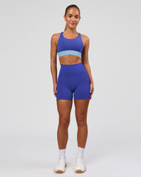 Woman wearing Fusion V-Contour Ultra High-Rise 4" Short Pockets - Power Cobalt | Model:Issy | Size:XS | Thumbnail Index: 3