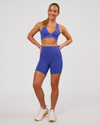 Woman wearing Fusion V-Contour Ultra High-Rise 6" Short Pockets - Power Cobalt | Model:Issy | Size:XS | Thumbnail Index: 3