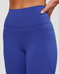 Woman wearing Fusion V-Contour Ultra High-Rise 7/8 Legging Pockets - Power Cobalt | Model:Issy | Size:XS | Thumbnail Index: 2