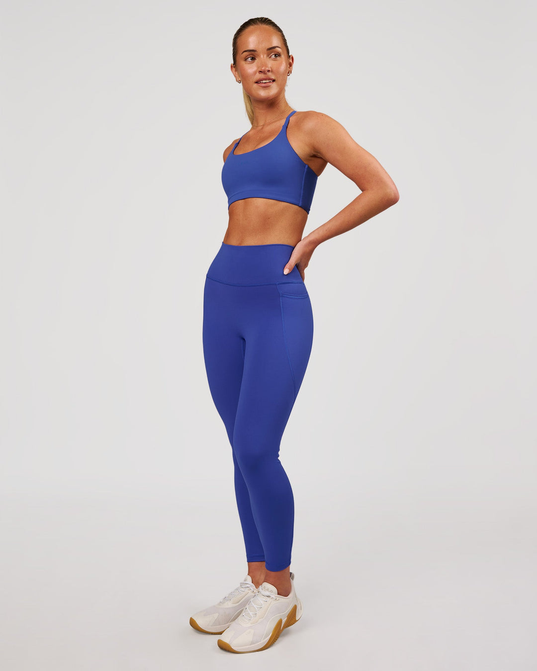 Woman wearing Fusion V-Contour Ultra High-Rise 7/8 Legging Pockets - Power Cobalt | Model:Issy | Size:XS - view 8