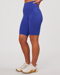 Woman wearing Fusion V Contour Ultra High-Rise 9" Short Pockets - Power Cobalt | Model:Issy | Size:XS | Thumbnail Index: 6