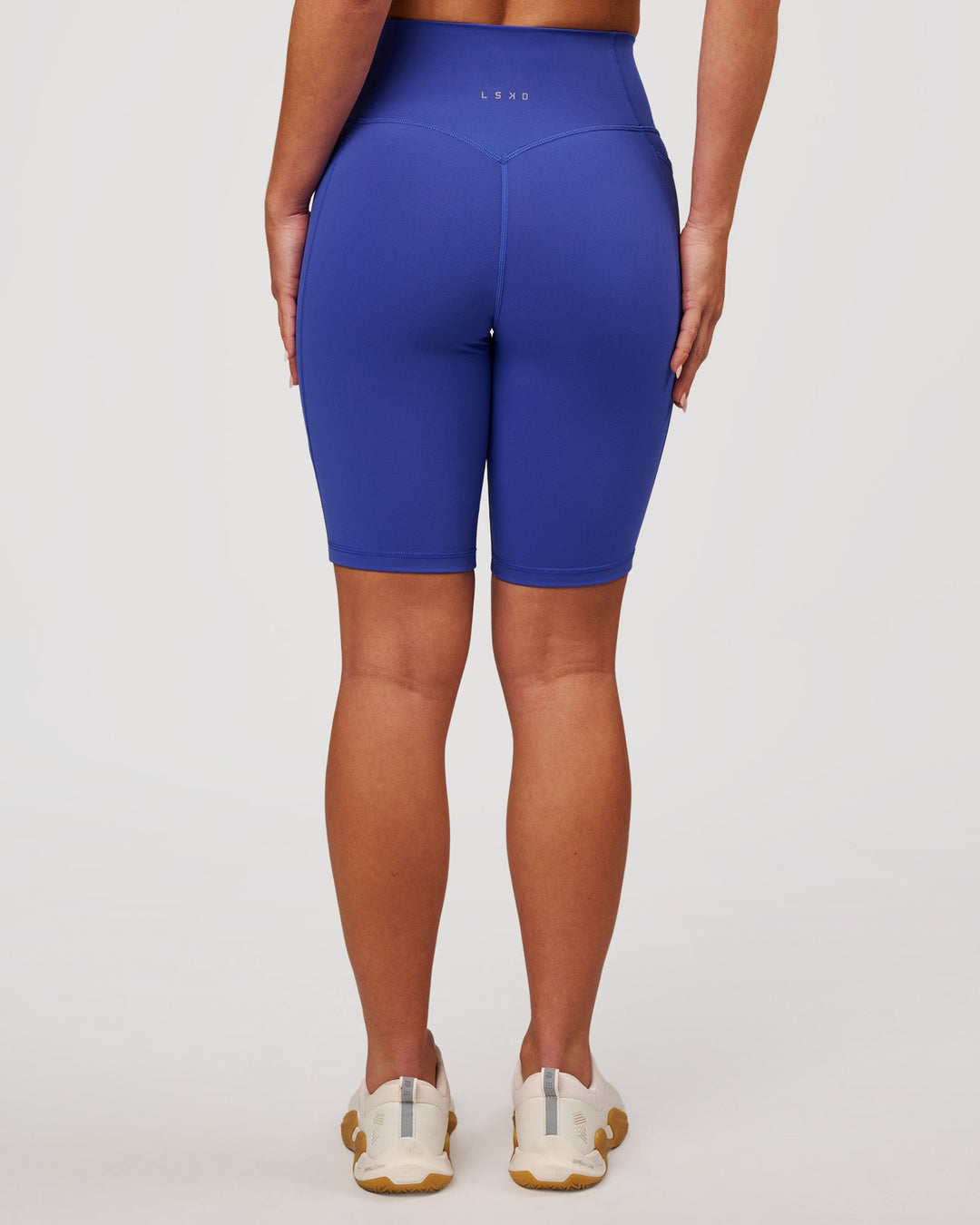 Woman wearing Fusion V Contour Ultra High-Rise 9" Short Pockets - Power Cobalt | Model:Issy | Size:XS - view 8
