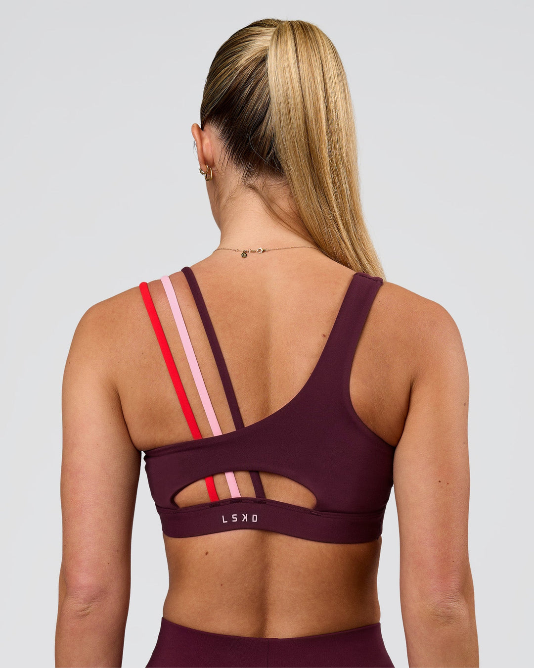 Woman wearing Galvanise Sports Bra 2.0 - Cherry Lacquer-Multi | Model:Issy | Size:XS - view 2