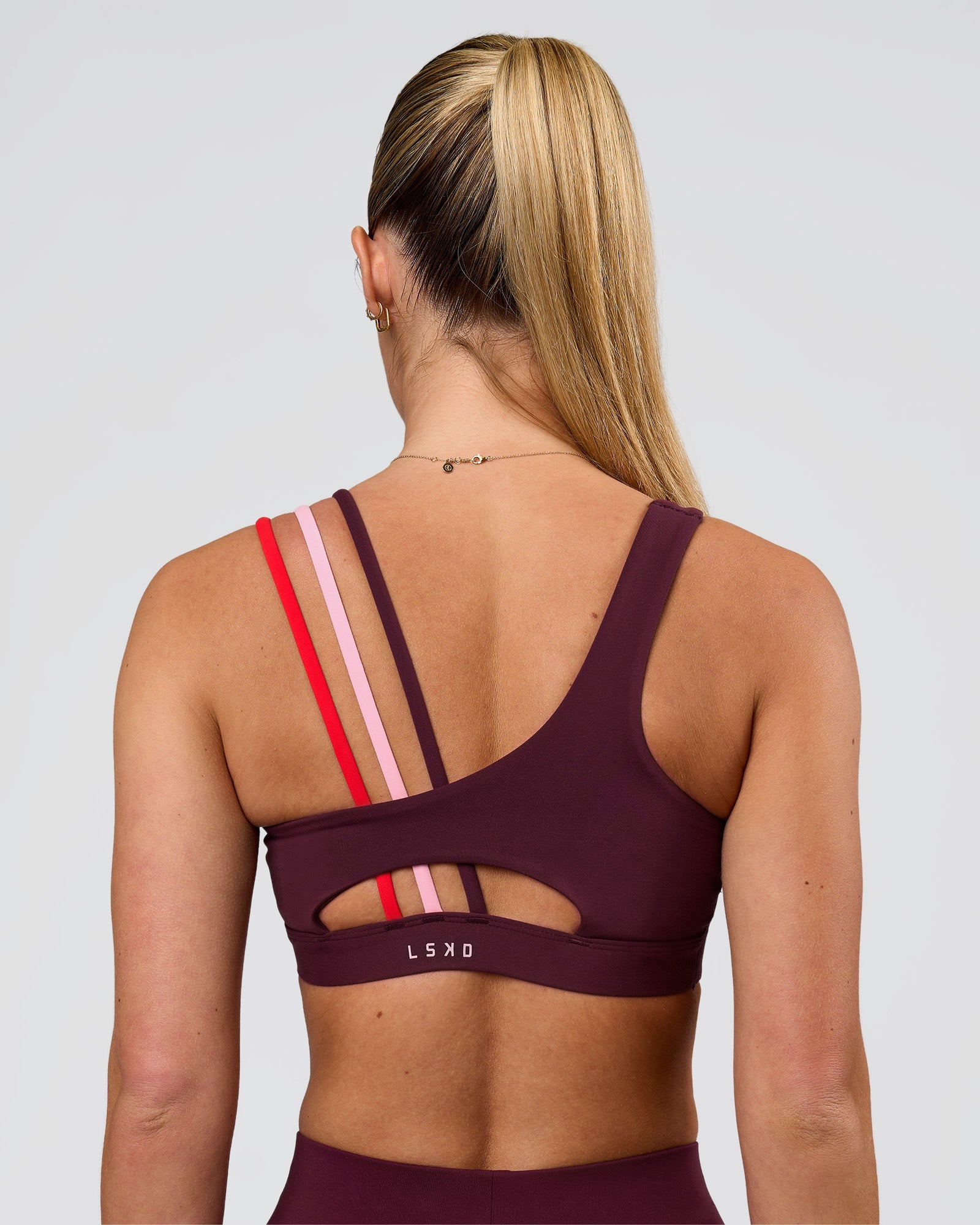Woman wearing Galvanise Sports Bra 2.0 - Cherry Lacquer-Multi | Model:Issy | Size:XS