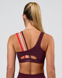 Woman wearing Galvanise Sports Bra 2.0 - Cherry Lacquer-Multi | Model:Issy | Size:XS | Thumbnail Index: 1
