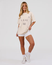 Woman wearing Game Plan Heavyweight FLXCotton Oversized Tee - Vanilla Bean | Model:Issy | Size:XS | Thumbnail Index: 8