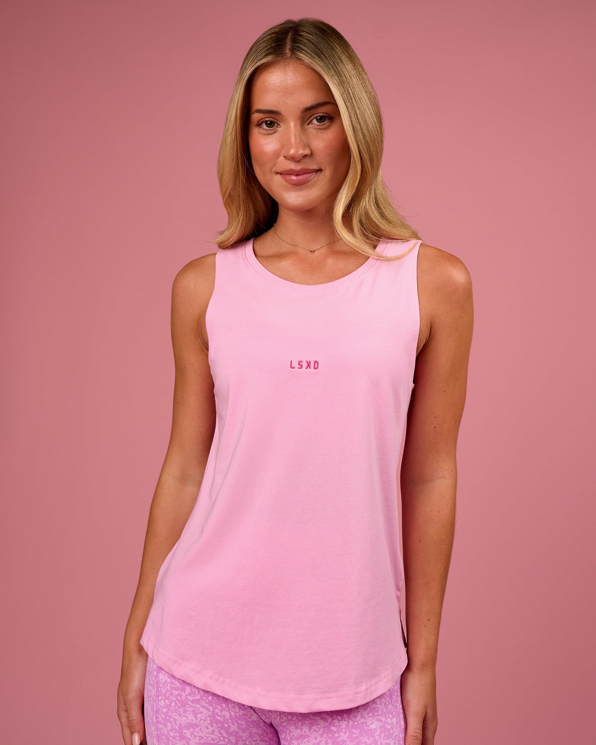 Woman wearing Go-To FLXCotton Longline Tank - Pink Rose-Ultra Pink | Model:Issy | Size:XS