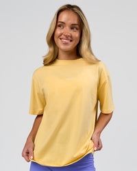 Woman wearing Go-To FLXCotton Oversized Tee - Lemon-White | Model:Issy | Size:XS | Thumbnail Index: 0