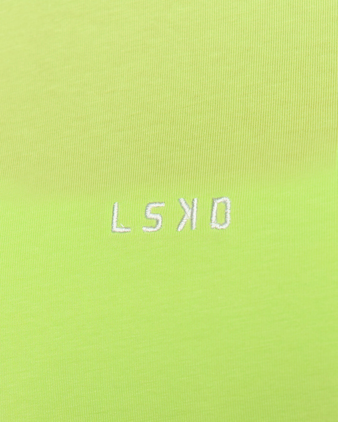 Woman wearing Go-To FLXCotton Oversized Tee - Lime Glo-White | Model:Issy | Size:XS - view 4