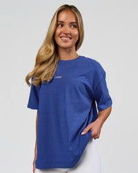 Woman wearing Go-To FLXCotton Oversized Tee - Power Cobalt-White | Model:Issy | Size:XS | Thumbnail Index: 0