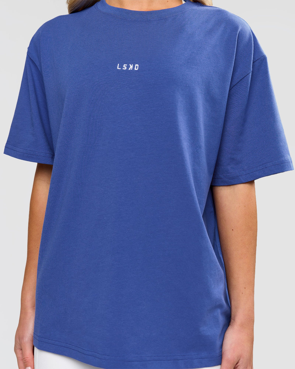 Woman wearing Go-To FLXCotton Oversized Tee - Power Cobalt-White | Model:Issy | Size:XS