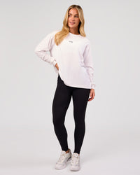 Woman wearing Go-To Long Sleeve FLXCotton Oversized Tee - White-Black | Model:Issy | Size:XS | Thumbnail Index: 5
