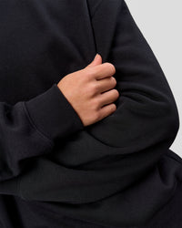 Woman wearing Go-To Oversized Sweater - Black | Model:Issy | Size:XS | Thumbnail Index: 6