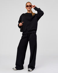 Woman wearing Go-To Oversized Sweater - Black | Model:Issy | Size:XS