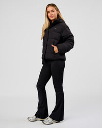 Woman wearing Go-To Puffer Jacket - Black | Model:Issy | Size:XS