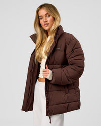 Woman wearing Go-To Puffer Mid Jacket - Hot Chocolate | Model:Issy | Size:XS | Thumbnail Index: 0