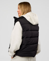 Woman wearing Go-To Puffer Vest - Black | Model:Issy | Size:XS