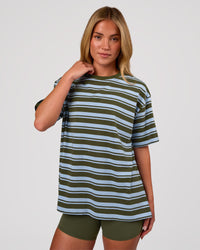 Woman wearing Go-To Shadow Stripe FLXCotton Oversized Tee - Pure Olive-Open Air | Model:Issy | Size:XS | Thumbnail Index: 0