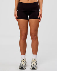 Woman wearing Groovy High Rise Fold Over 4" Short - Black | Model:Issy | Size:XS