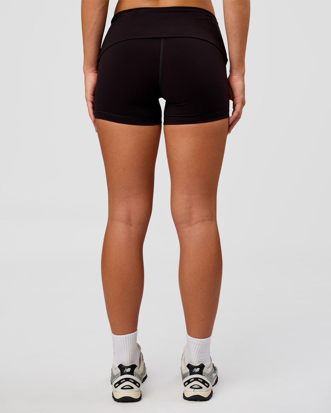 Woman wearing Groovy High Rise Fold Over 4" Short - Black | Model:Issy | Size:XS
