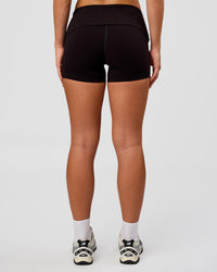 Woman wearing Groovy High Rise Fold Over 4" Short - Black | Model:Issy | Size:XS