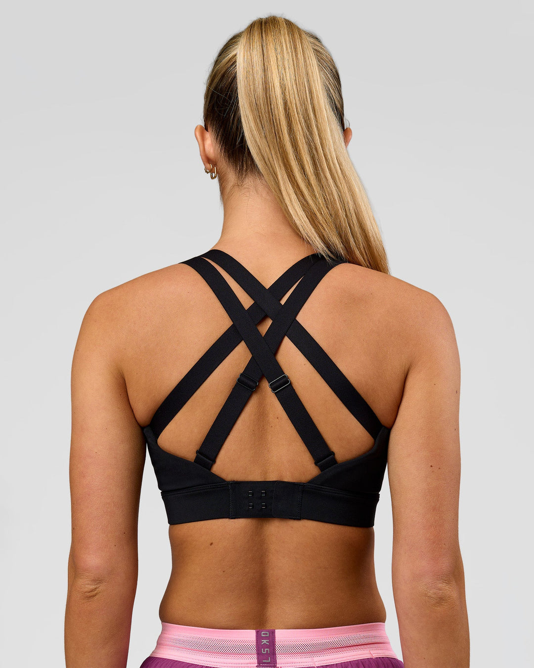 Woman wearing High Velocity Sports Bra - Black | Model:Issy | Size:XS - view 2