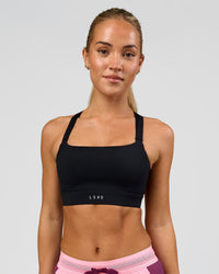 Woman wearing High Velocity Sports Bra - Black | Model:Issy | Size:XS | Thumbnail Index: 0