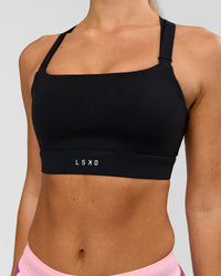 Woman wearing High Velocity Sports Bra - Black | Model:Issy | Size:XS | Thumbnail Index: 2