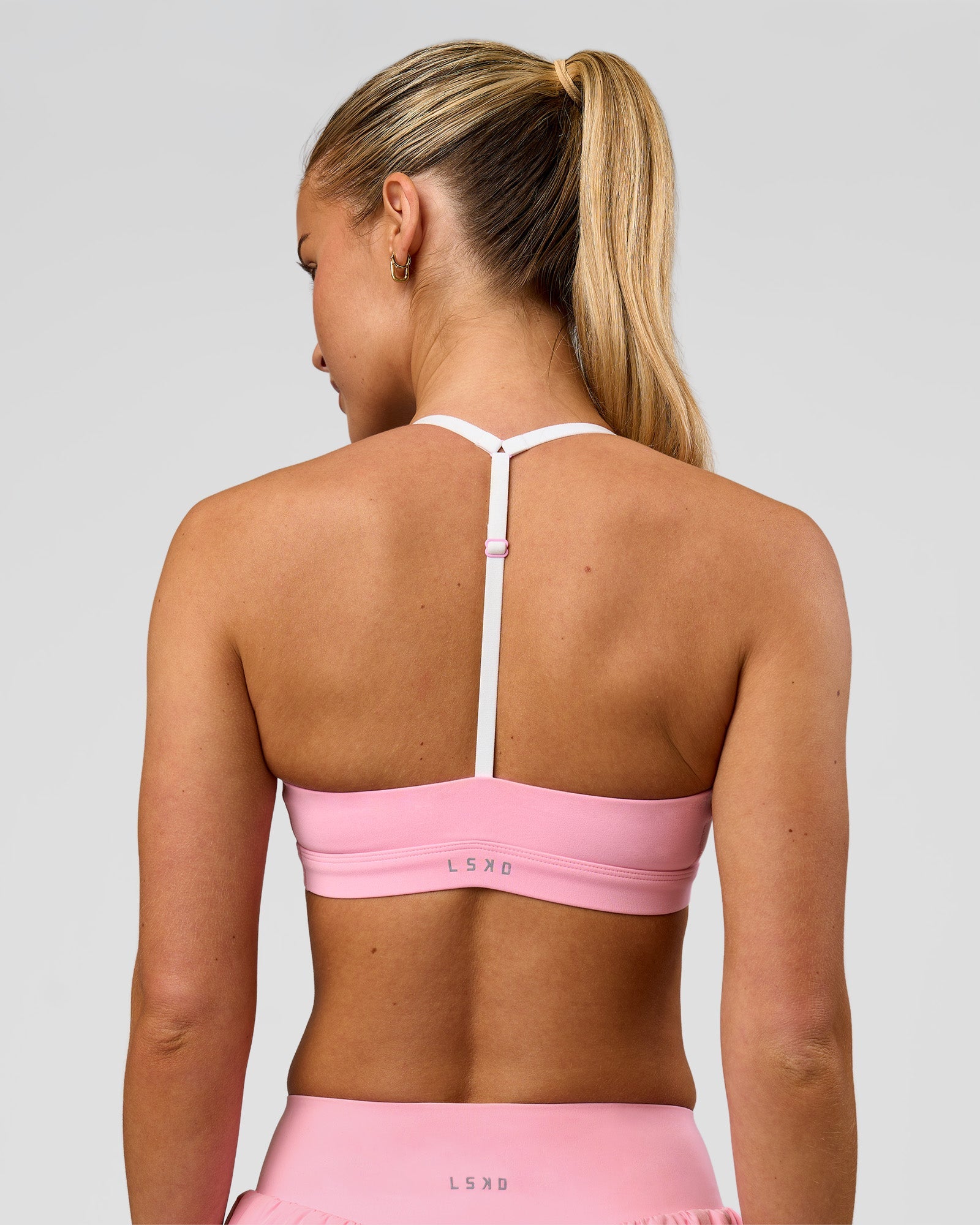 Woman wearing Infinity Sports Bra - Pink Rose | Model:Issy | Size:XS