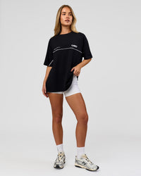 Woman wearing Inline Heavyweight FLXCotton Oversized Tee - Black-White | Model:Issy | Size:XS | Thumbnail Index: 10