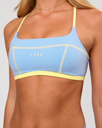 Woman wearing Liberate Sports Bra - Open Air-Lemon | Model:Issy | Size:XS | Thumbnail Index: 0