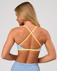 Woman wearing Liberate Sports Bra - Open Air-Lemon | Model:Issy | Size:XS | Thumbnail Index: 2