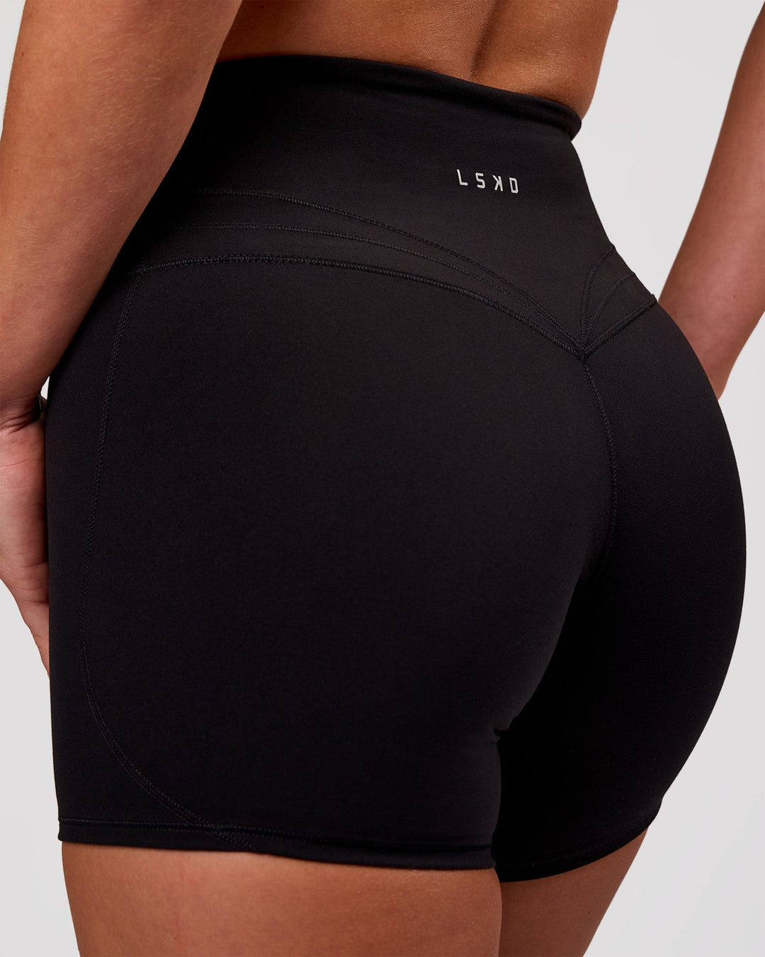 Woman wearing Luxe V-Contour High-Rise 4" Short - Black | Model:Issy | Size:XS - view 1