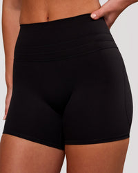 Woman wearing Luxe V-Contour High-Rise 4" Short - Black | Model:Issy | Size:XS | Thumbnail Index: 1