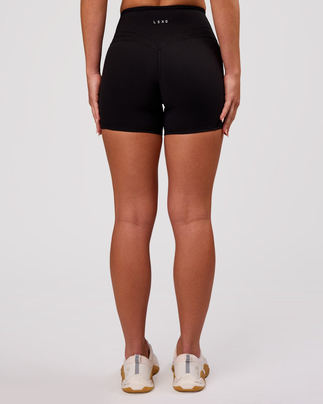 Woman wearing Luxe V-Contour High-Rise 4" Short - Black | Model:Issy | Size:XS - view 5