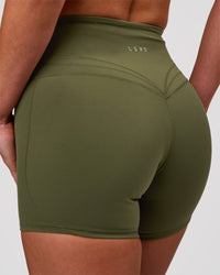 Woman wearing Luxe V-Contour High-Rise 4" Short - Pure Olive | Model:Issy | Size:XS | Thumbnail Index: 0