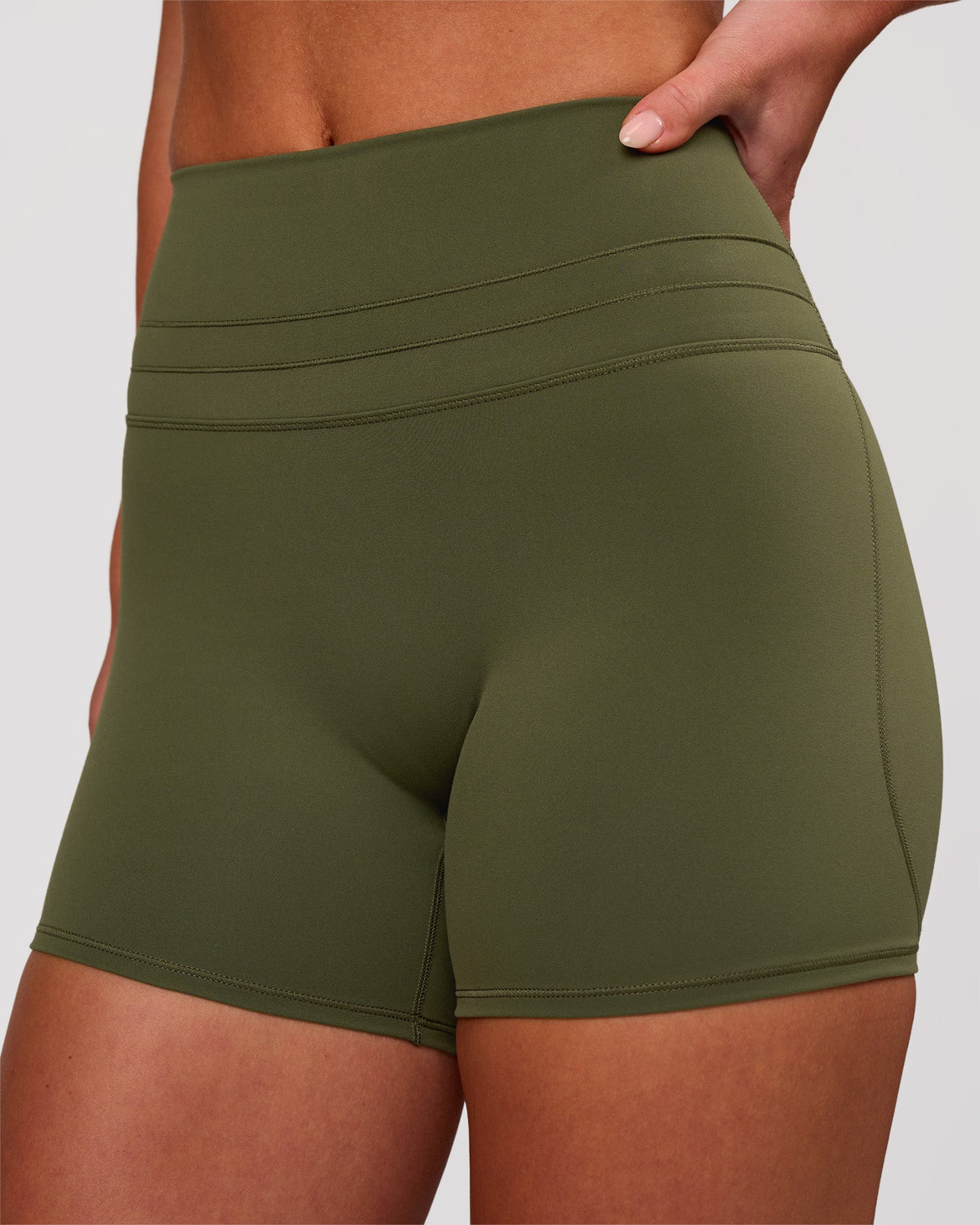 Woman wearing Luxe V-Contour High-Rise 4" Short - Pure Olive | Model:Issy | Size:XS