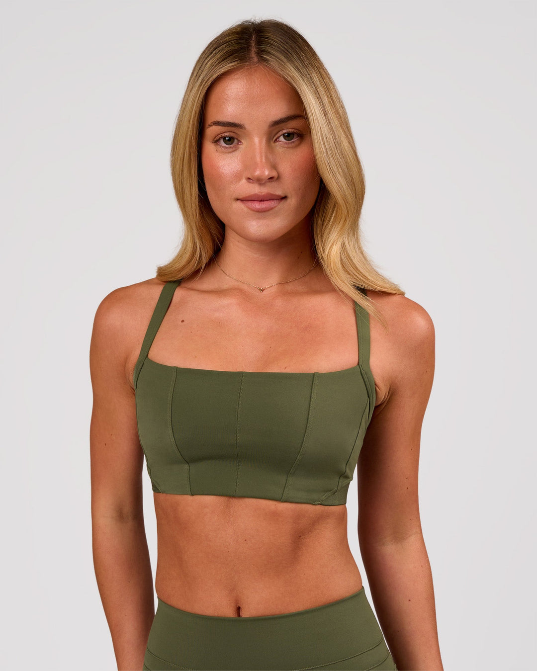 Woman wearing Momentum Corset Sports Bra - Pure Olive | Model:Issy | Size:XS - view 3