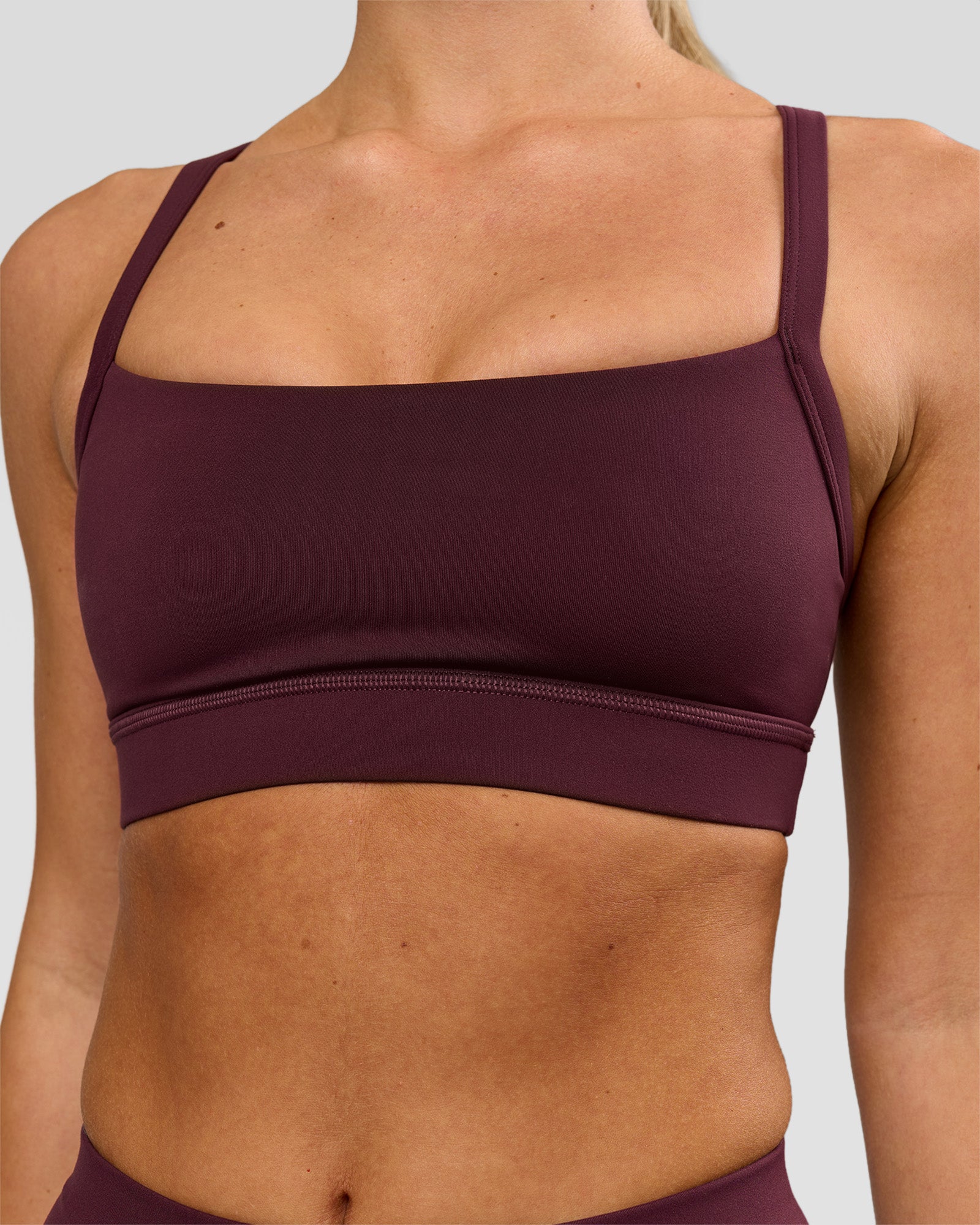 Woman wearing Momentum Sports Bra - Cherry Lacquer | Model:Issy | Size:XS
