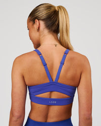 Woman wearing Momentum Sports Bra - Power Cobalt | Model:Issy | Size:XS | Thumbnail Index: 1