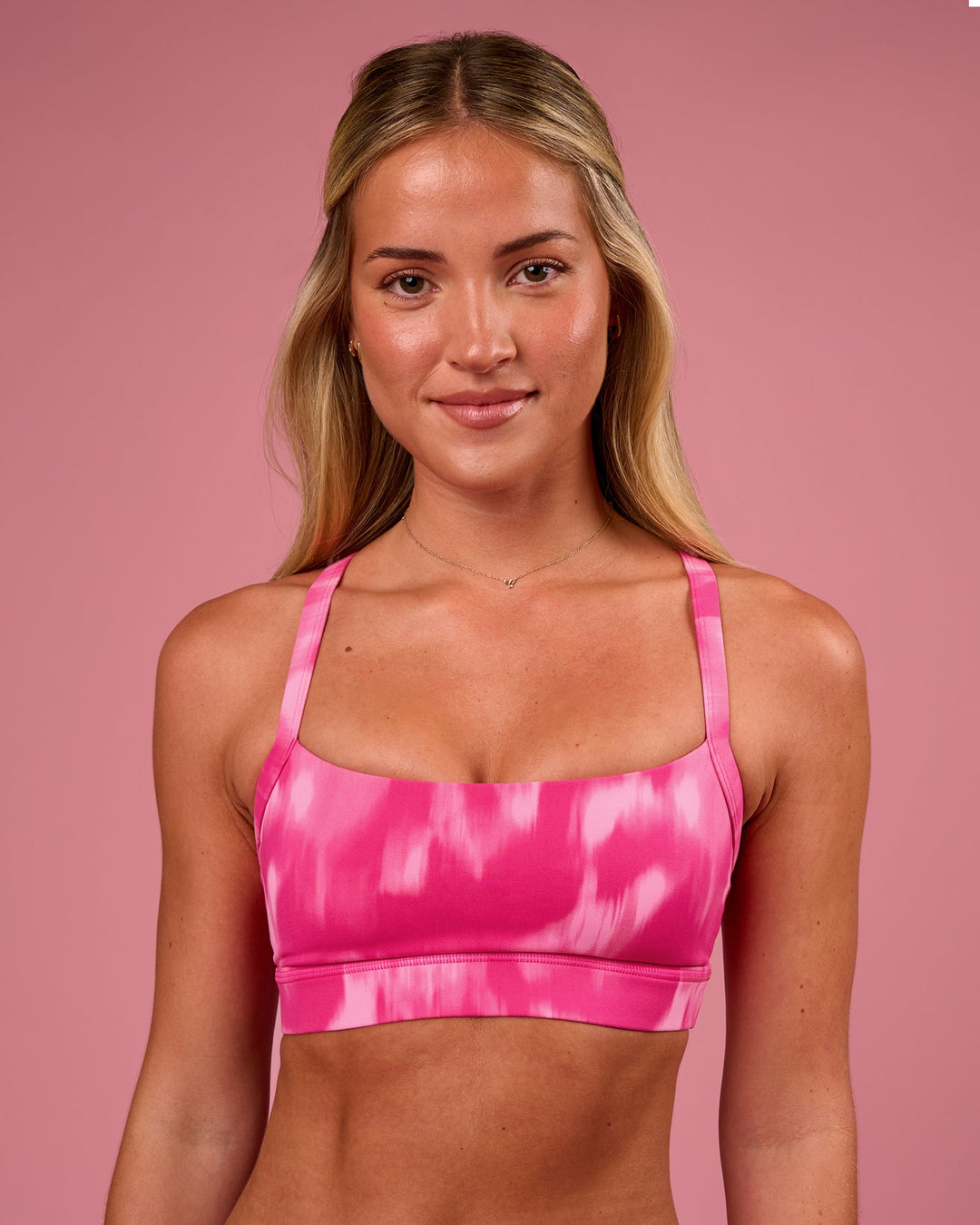 Woman wearing Momentum Sports Bra - Radiant Pink | Model:Issy | Size:XS - view 1