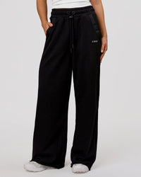 Woman wearing MVP Elite Terry Wide Leg Pant - Black-White | Model:Issy | Size:XS | Thumbnail Index: 0