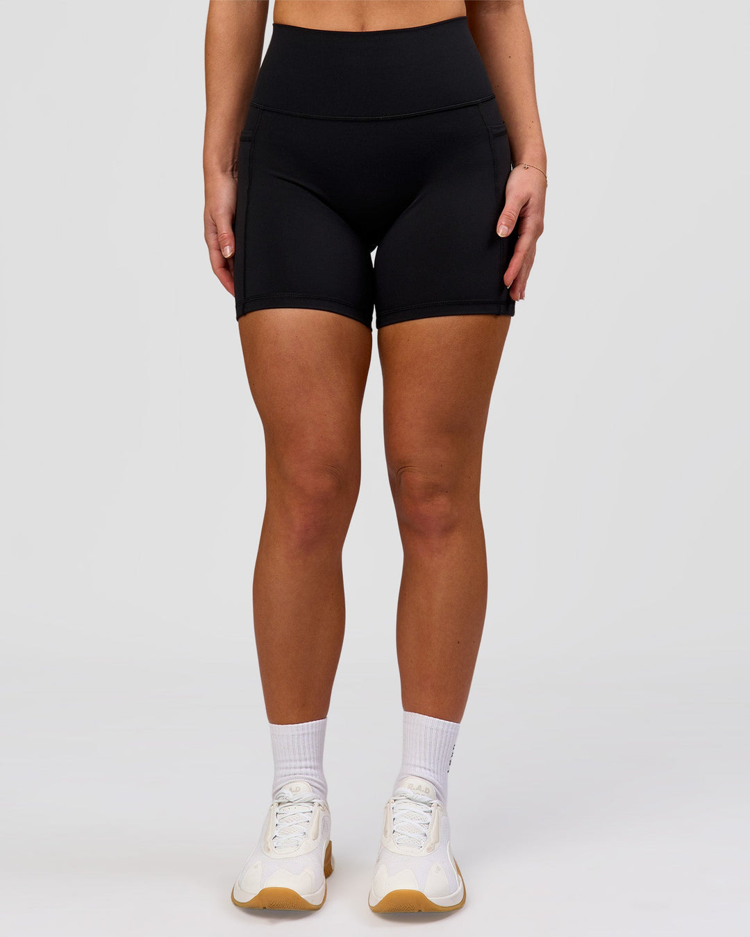 Woman wearing O.G. Fusion Ultra High-Rise 6" Short Pockets - Black | Model:Issy | Size:XS - view 5