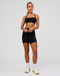 Woman wearing O.G. Fusion Ultra High-Rise 6" Short Pockets - Black | Model:Issy | Size:XS | Thumbnail Index: 12