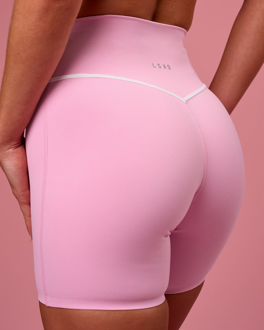 Woman wearing Pinnacle High-Rise 6" Short - Pink Rose-White | Model:Issy | Size:XS - view 1