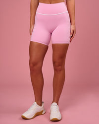 Woman wearing Pinnacle High-Rise 6" Short - Pink Rose-White | Model:Issy | Size:XS | Thumbnail Index: 5