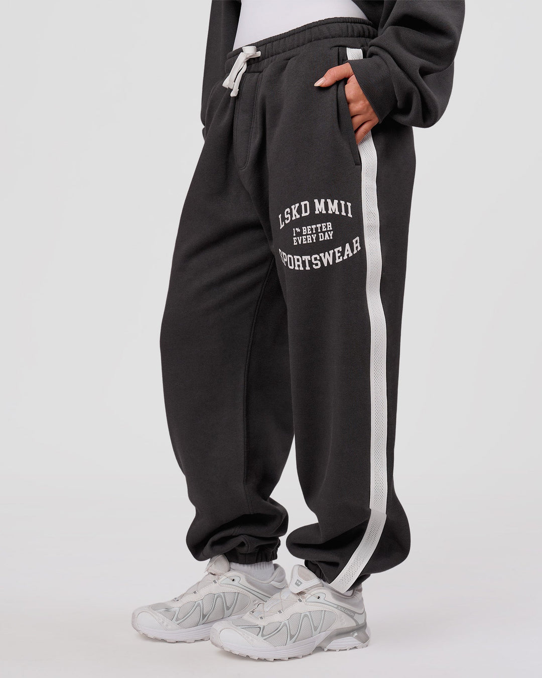 Woman wearing Playbook Baggy Cuffed Track Pant - Onyx-Off White | Model:Issy | Size:XS - view 4