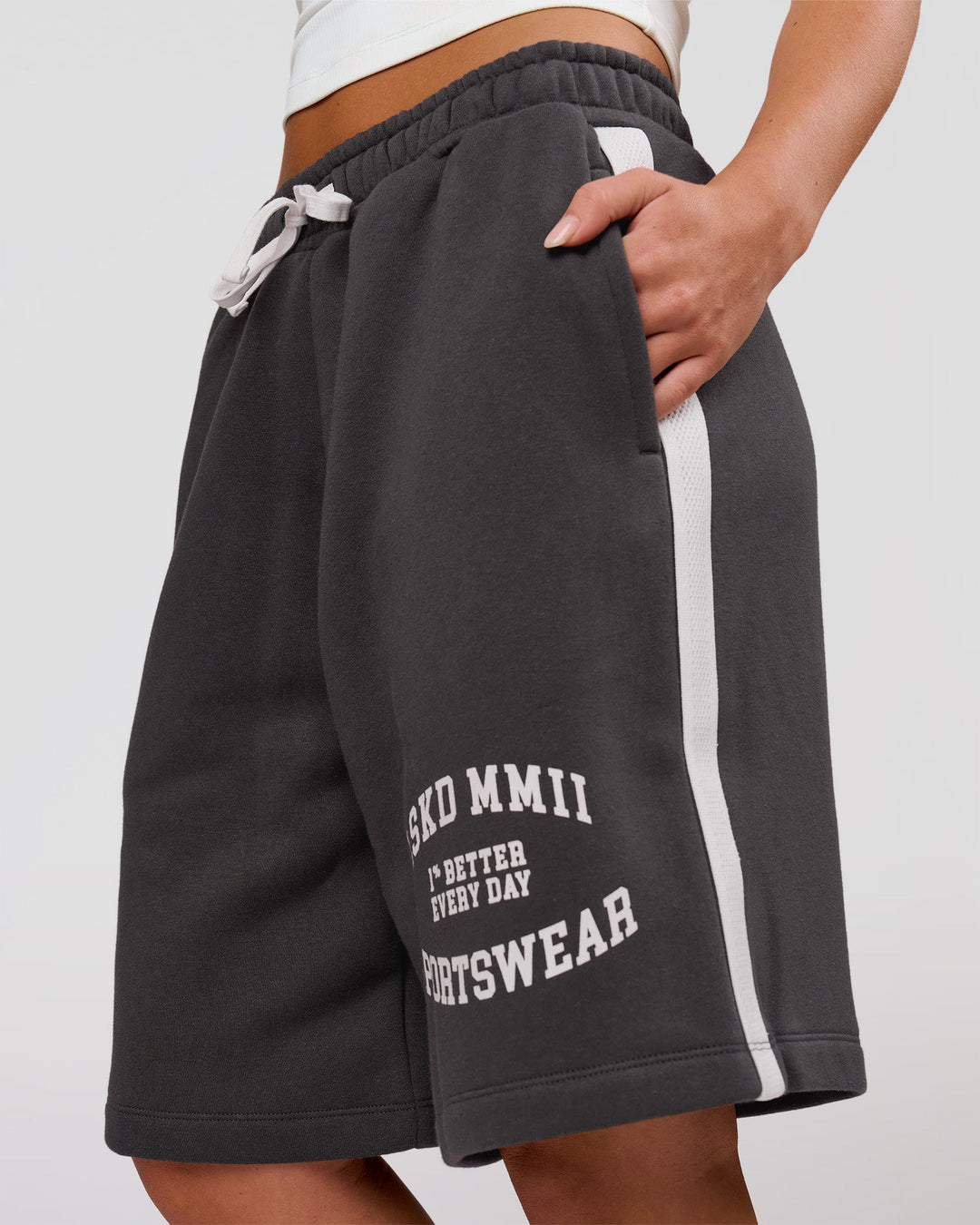 Woman wearing Playbook Varsity Fleece Shorts - Onyx-Off White | Model:Issy | Size:XS - view 14